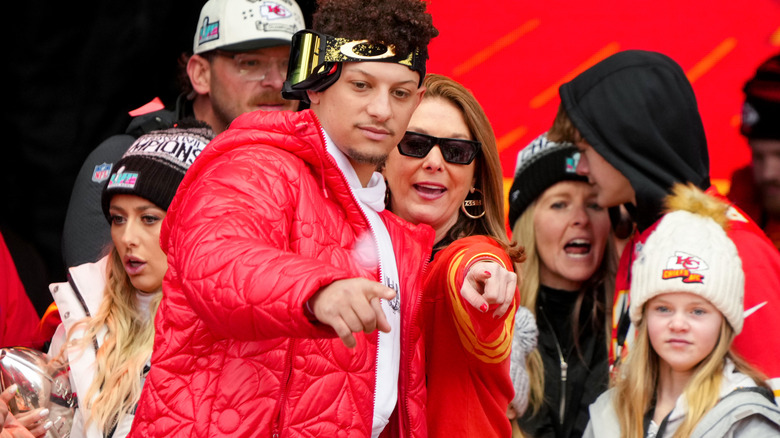 Patrick and Randi Mahomes standing side by side and pointing