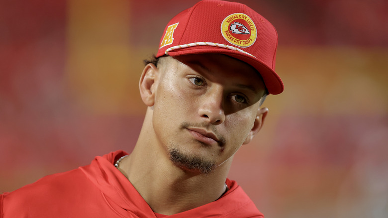 Patrick Mahomes wearing a Chiefs cap on field