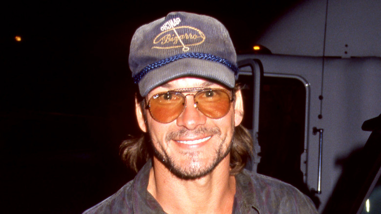 Patrick Swayze in sunglasses and a hat