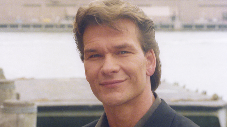 Patrick Swayze posing outdoors