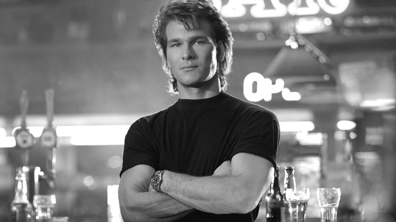 Patrick Swayze posing in a bar