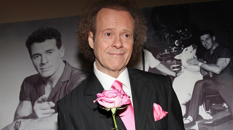 Richard Simmons black suit pink rose