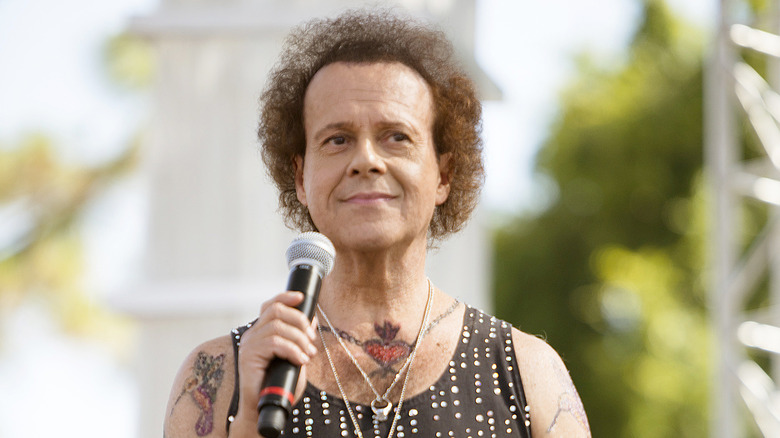 Richard Simmons holding microphone