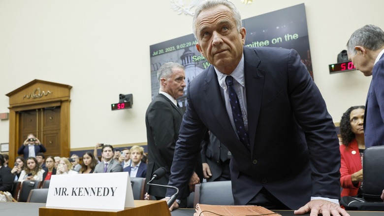 RFK Jr. leaning on a desk