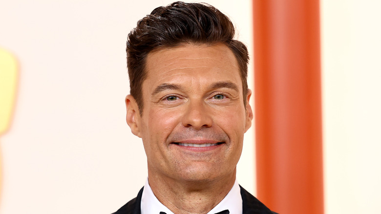 Ryan Seacrest smiles in a tux