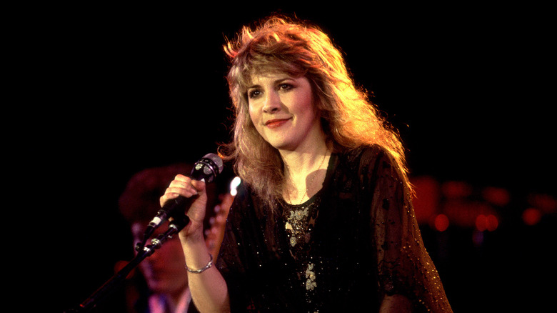 Stevie Nicks wearing a black crocheted sweater and black lace dress