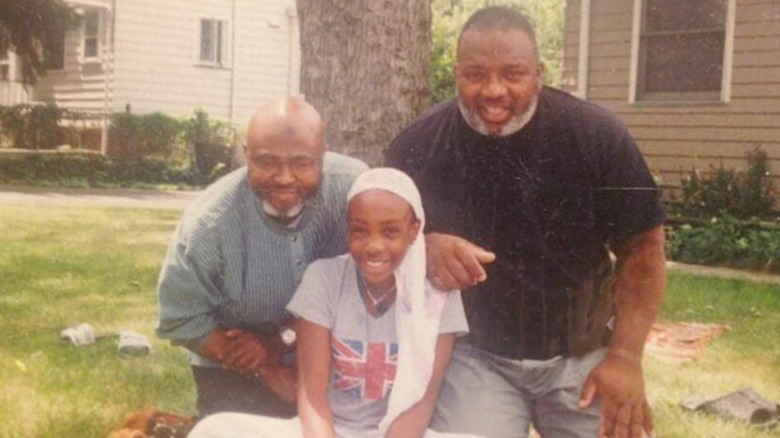 A young SZA poses with her uncles.