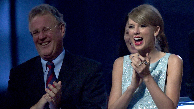 Scott and Taylor Swift clapping and smiling