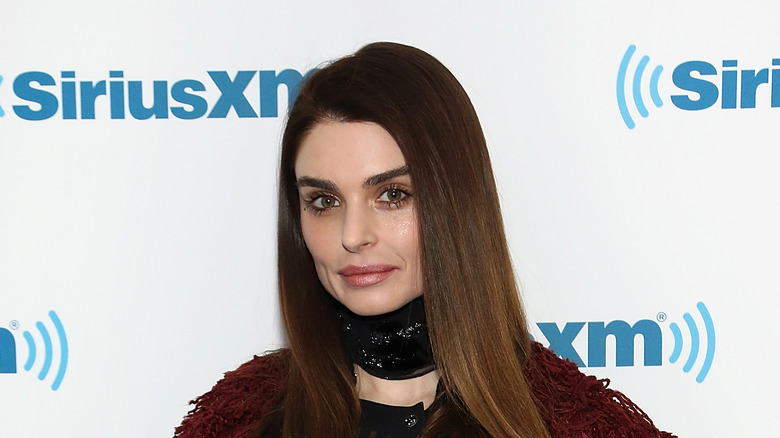 Aimee Osbourne stands in black choker