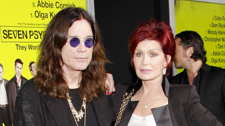 Ozzy Osbourne and Sharon Osbourne stand at movie premiere