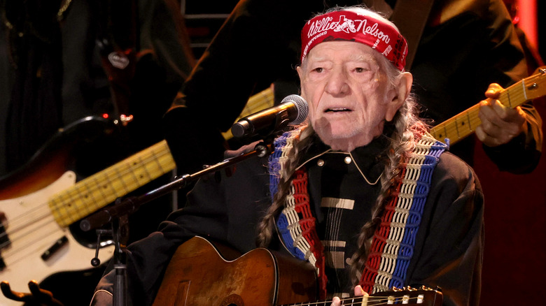 Willie Nelson playing guitar