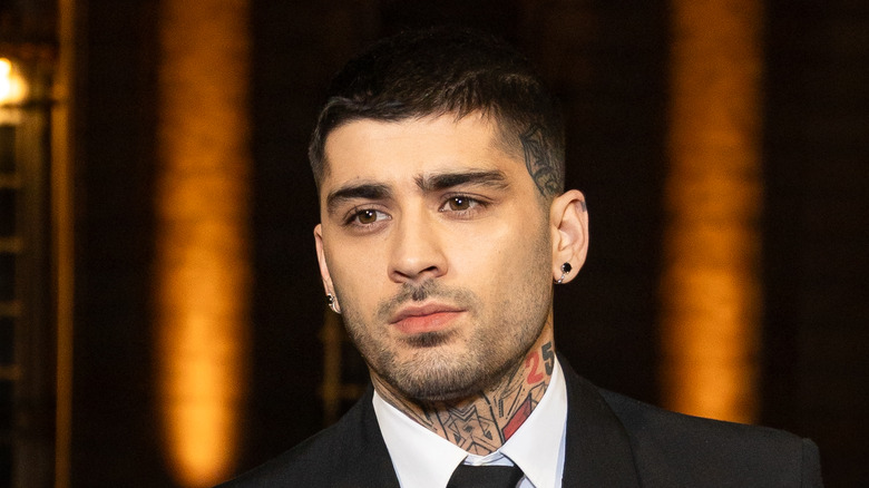 Zayn Malik wearing a black suit