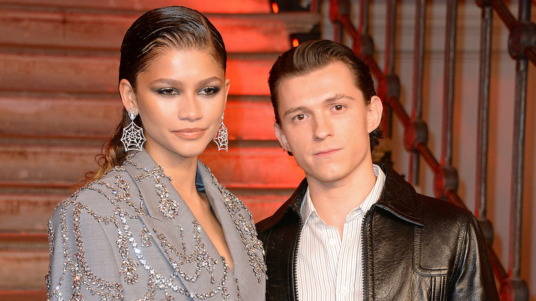 Zendaya posing beside Tom Holland