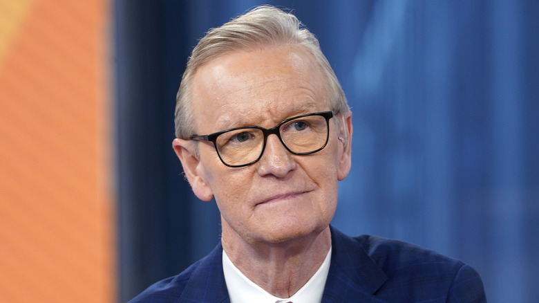 Steve Doocy looks ahead with serious expression