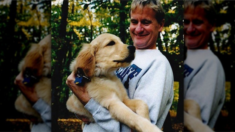 Steve Doocy holds his golden retriever Charlie