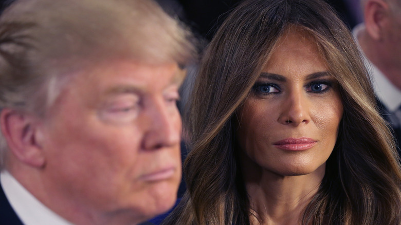 Melania Trump glaring while Donald Trump is in the foreground