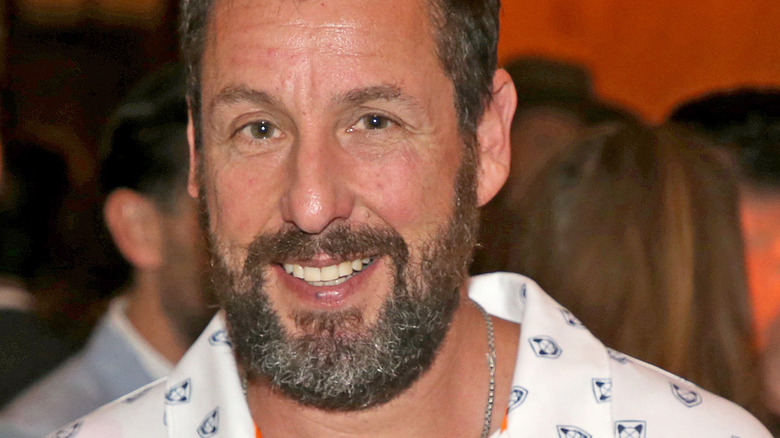 Adam Sandler smiling in 2022