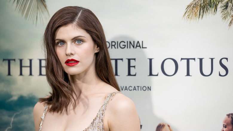 Alexandra Daddario poses in a sequined dress and red lipstick.
