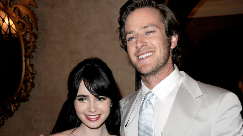 Armie Hammer and Lily Collins smiling 