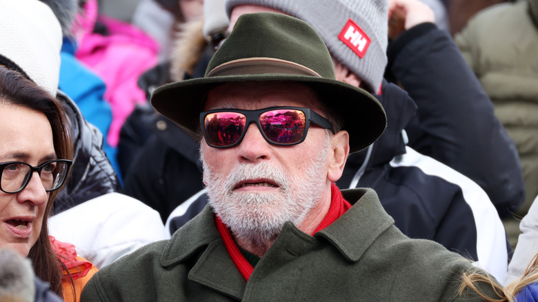 Arnold Schwarzenegger wearing a hat and sunglasses