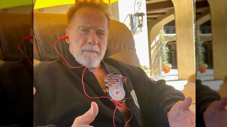 Arnold Schwarzenegger showing off his faux "pacemaker"