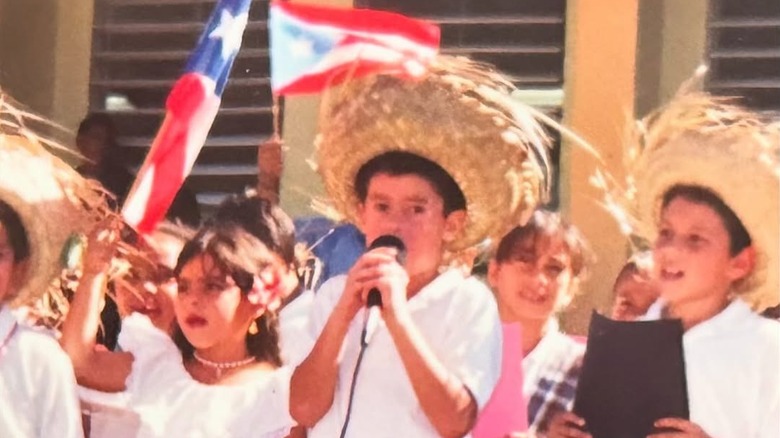 Bad Bunny as a child performing wearing a straw hat