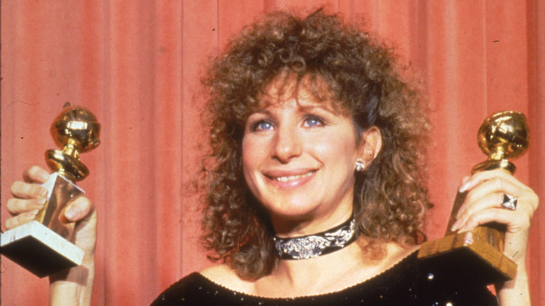 Barbra Streisand holding two Golden Globes