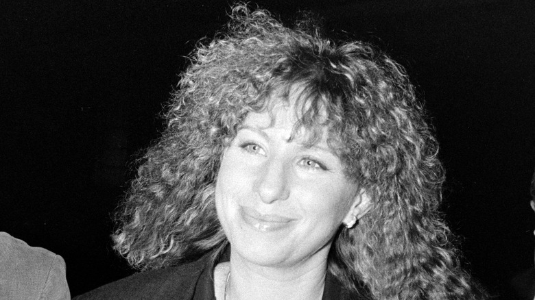 Barbra Streisand smirking with curly hair