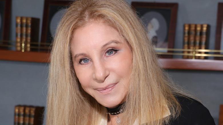 Barbra Streisand holding a medal