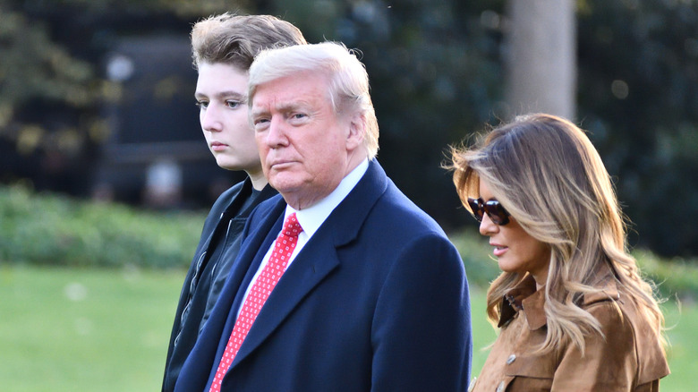 Barron, Donald and Melania Trump outdoors