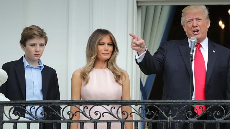 Barron, Donald and Melania Trump behind railing