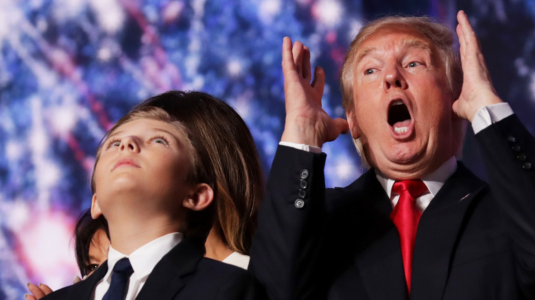 Barron Trump gazing up beside Donald Trump