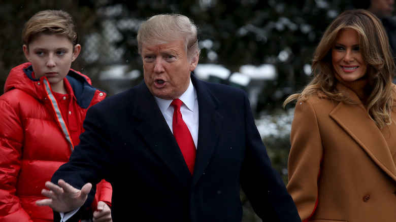 Melania Trump smiling beside Donald, Barron Trump