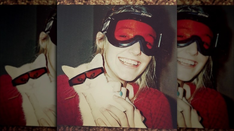 Blake Lively posing with a cat and wearing goggles as a teenager