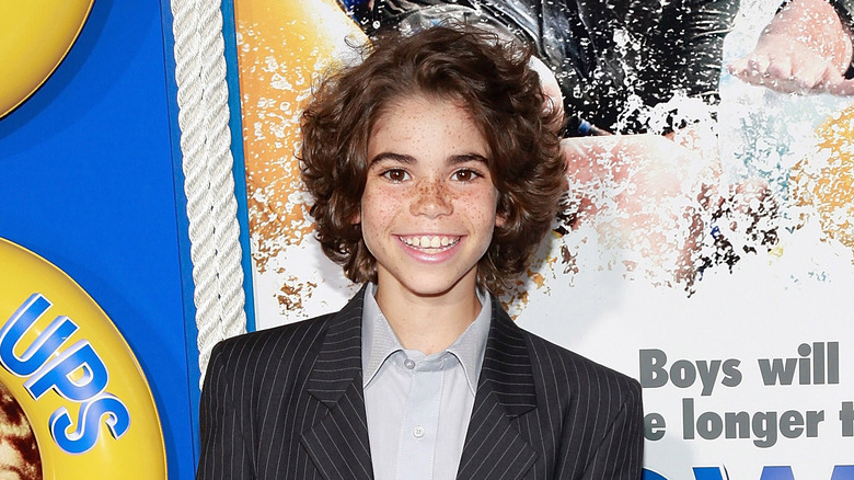 Cameron Boyce poses for a photo in pinstripe suit