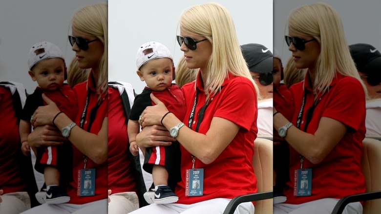 Elin Nordegren holding a young Charlie Woods in 2009