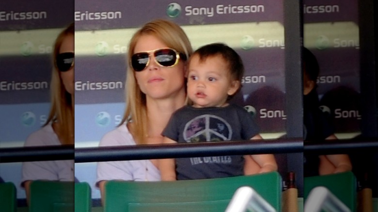 Charlie Woods sitting in Elin Nordegren's lap in 2010