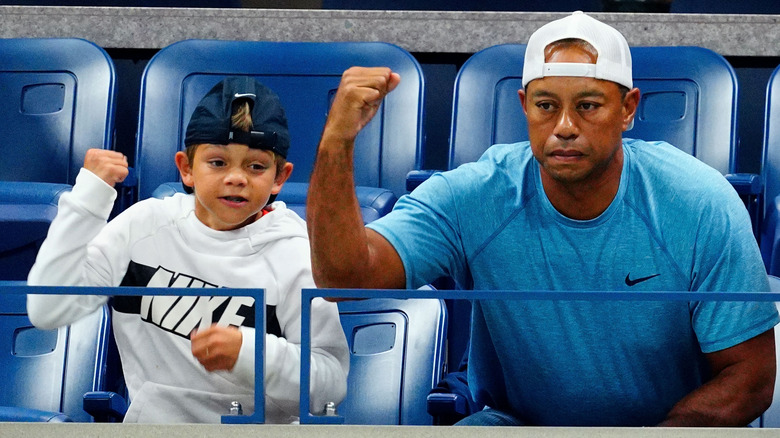 Charlie Woods and Tiger Woods cheering in 2019