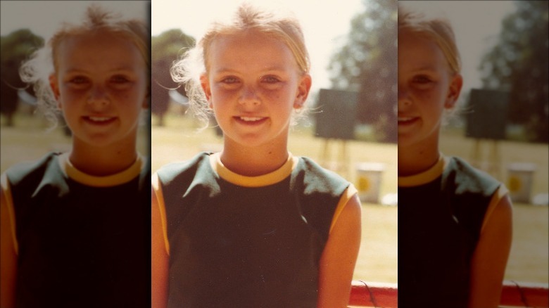 Charlize Theron smiles as a child