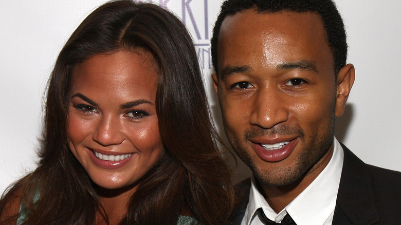 Young Chrissy Teigen and John Legend smiling