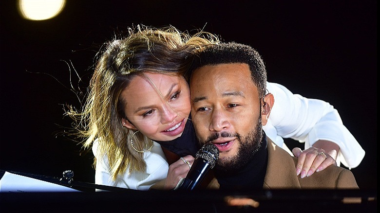 Chrissy Teigen hugs John Legend on stage