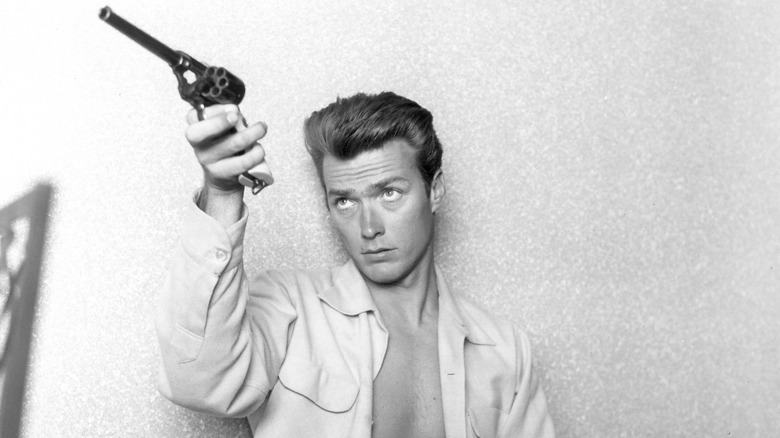 Clint Eastwood holding a pistol in 1956.