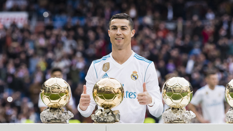 Cristiano Ronaldo with his Ballon D'Or trophies