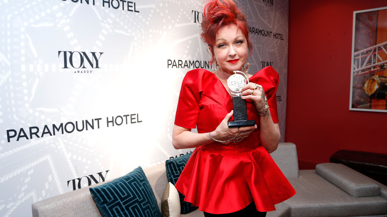 Cyndi Lauper holding a Tony Award