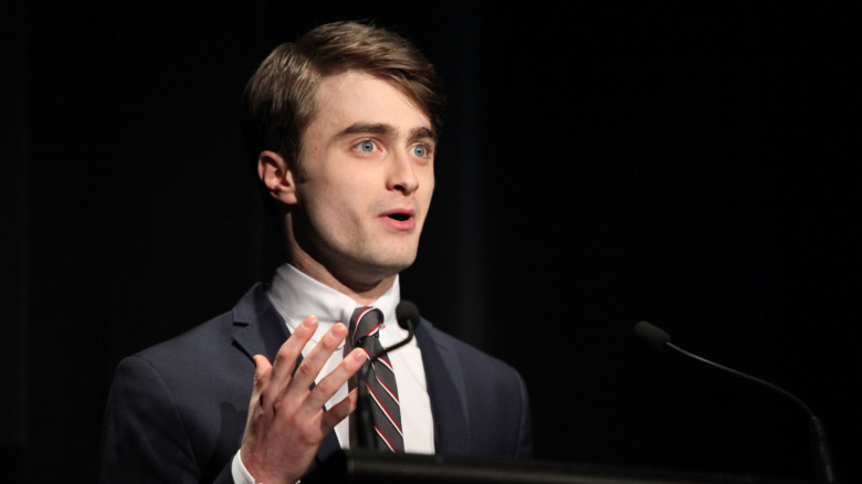 Daniel Radcliffe speaks on stage in 2011.