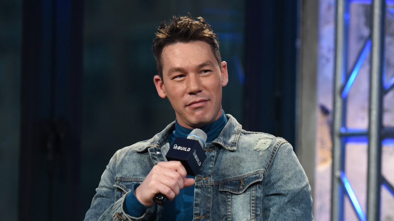 David Bromstad holding microphone at AOL Build Studios