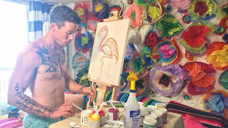 David Bromstad painting in his studio