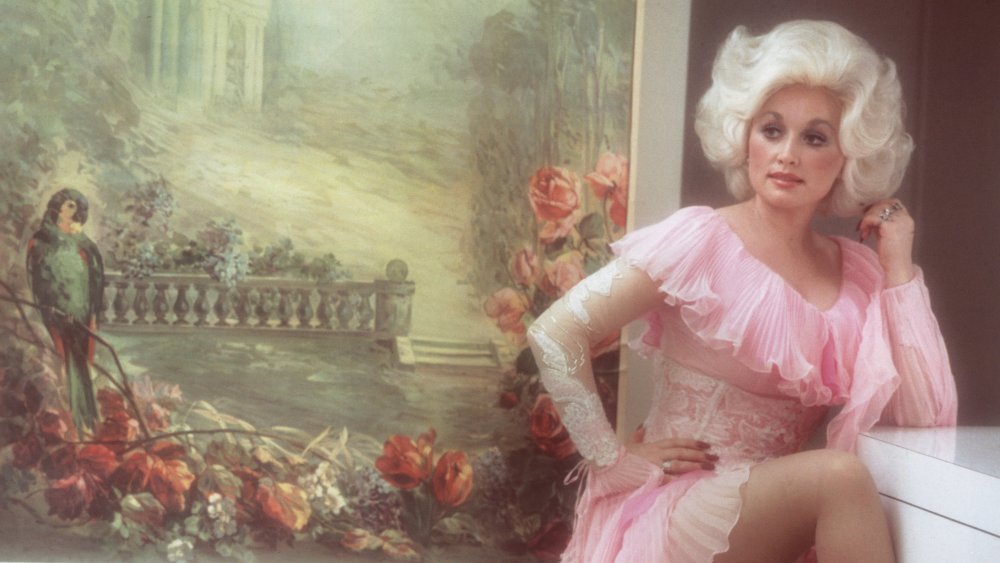 Dolly Parton in a white-and-pink lace dress in 1978 at age 32