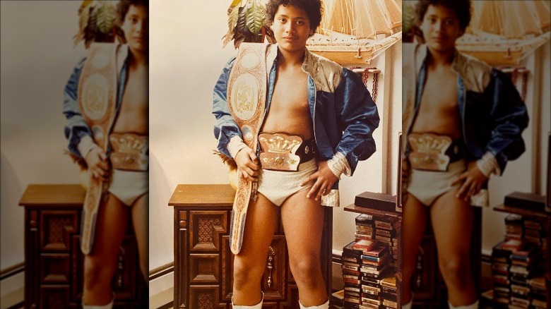 Dwayne Johnson with wrestling belts