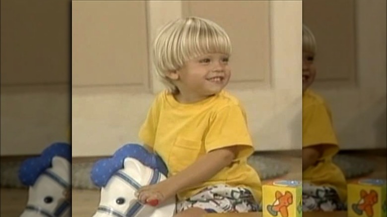 Dylan or Cole Sprouse on rocking horse